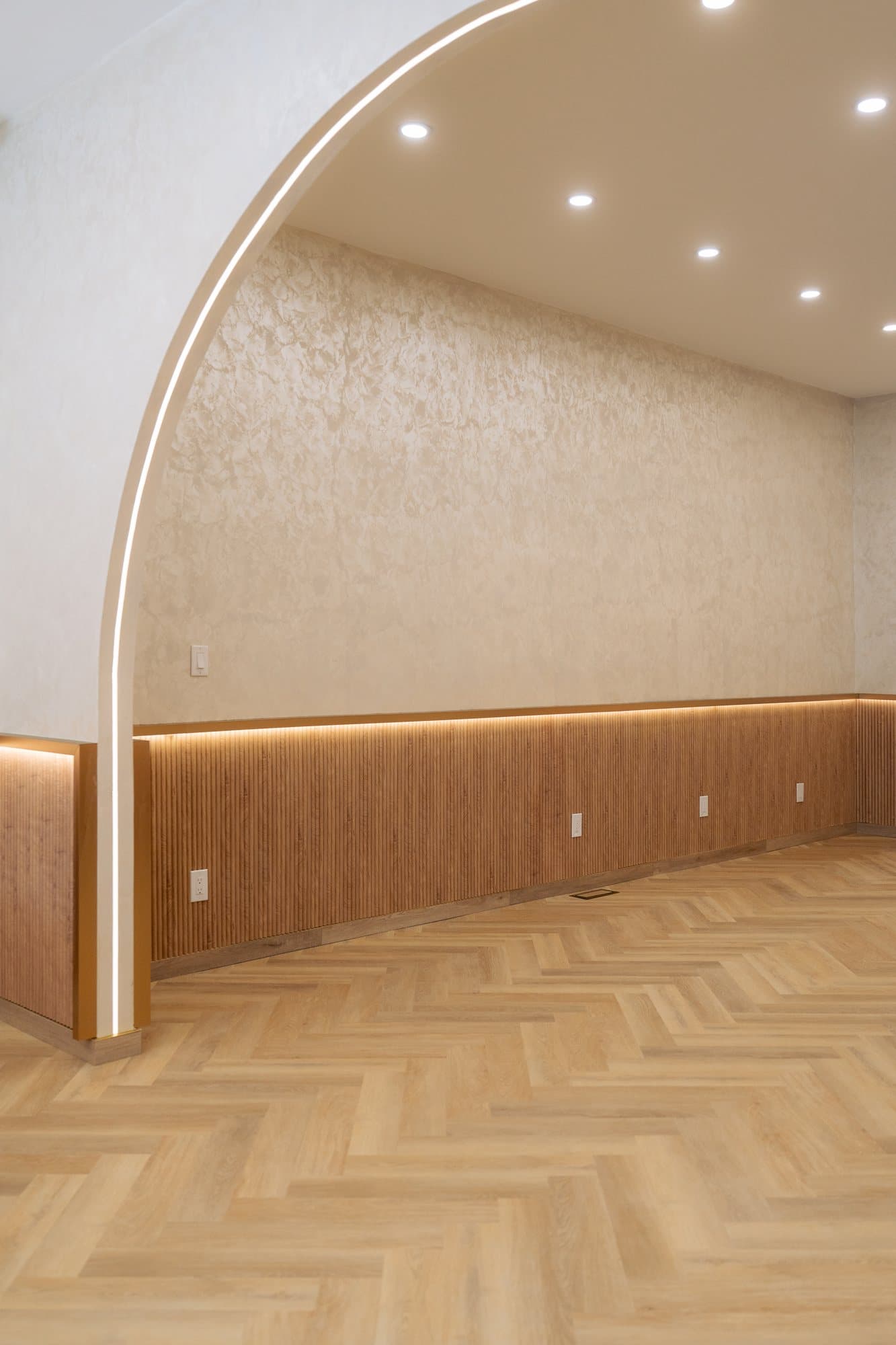 A finished plastered arch outlined by a continuous cove light