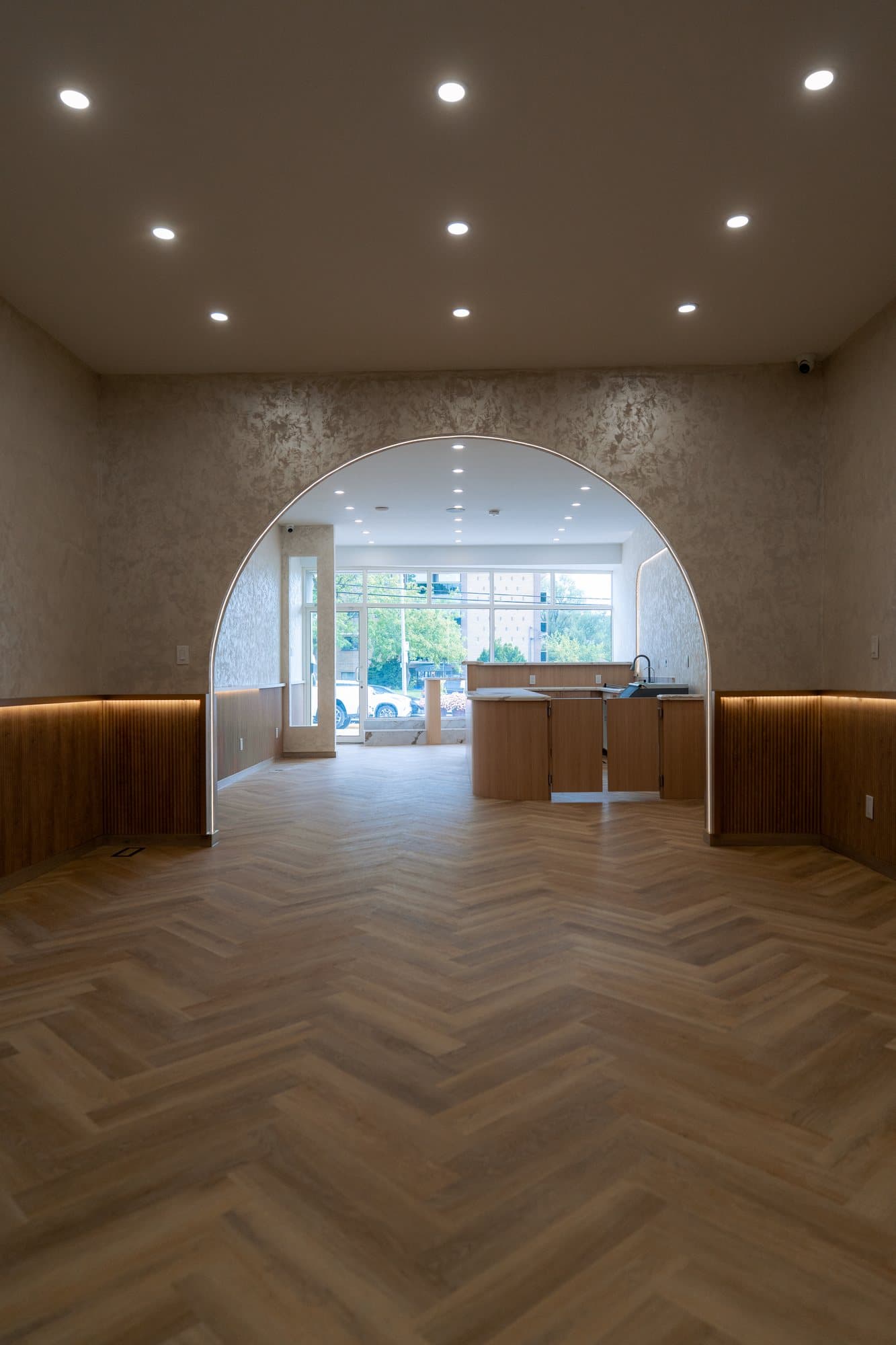 Looking through a plastered arch from the dining room toward the curved oak service counter