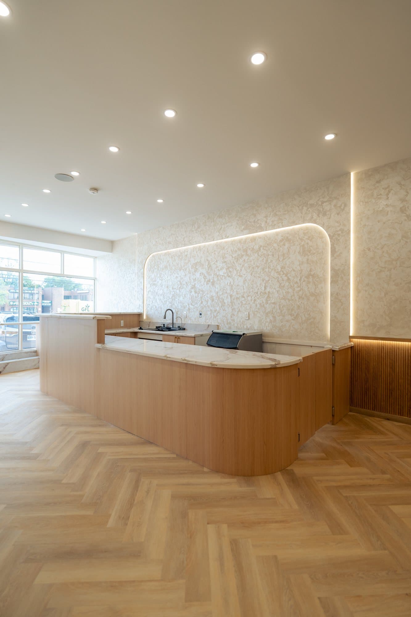 The service island with cove lighting behind the plaster arch
