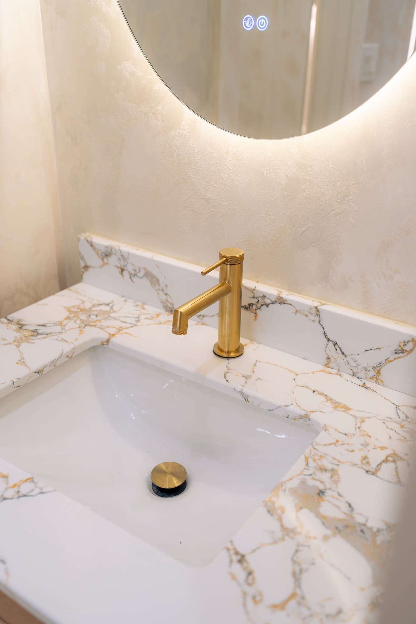 A brass tap set into a marble vanity top